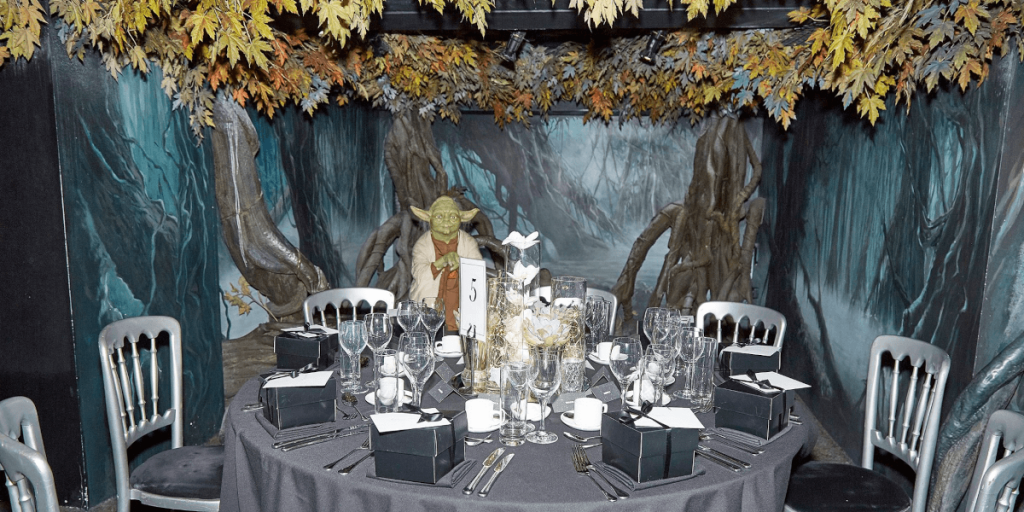 A dinner table with Yoda form Star Wars as a dinner guest